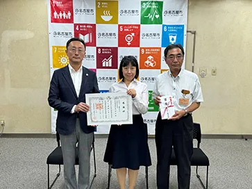 This photo shows the Environment Bureau Director of Nagoya, Aichi Pref. with NGK employees.