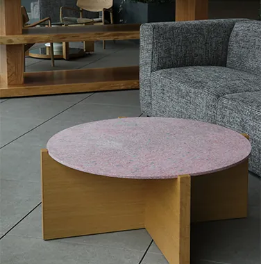 A photograph of a table and facility signs made from waste plastic generated during the manufacturing process.